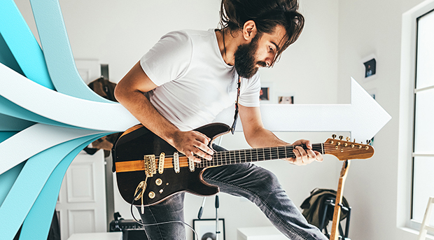 A man plays his electric guitar excitedly while his savings grow in his Essential Saver account.